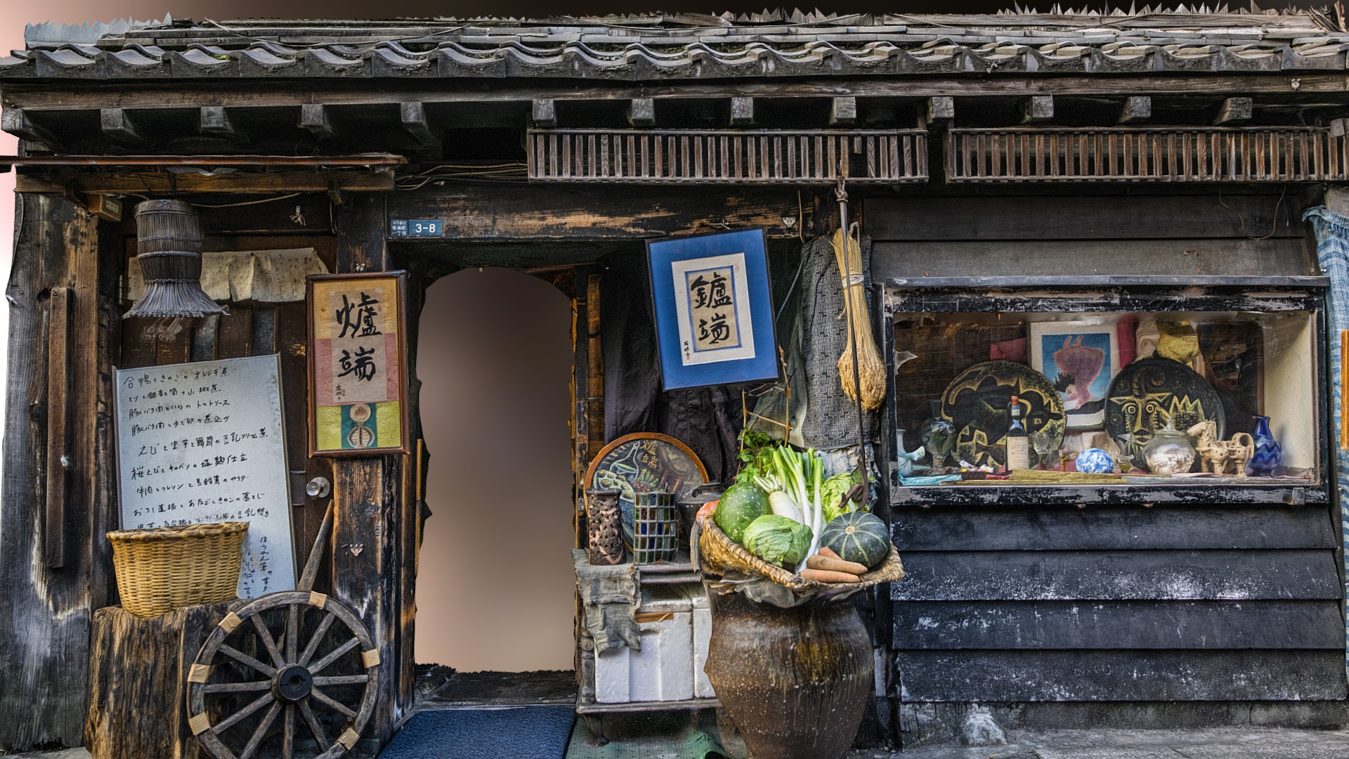 3D model Japanese shop photogrammetry scan - This is a 3D model of the Japanese shop photogrammetry scan. The 3D model is about a building with a wood door and a cart with plants and a basket.