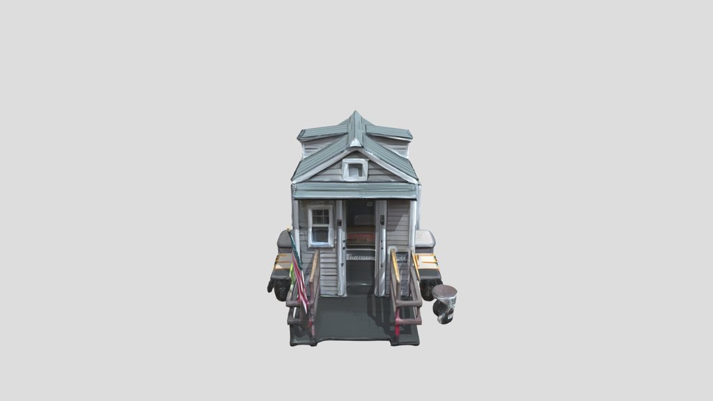 Small pink tiny house on a grassy lot