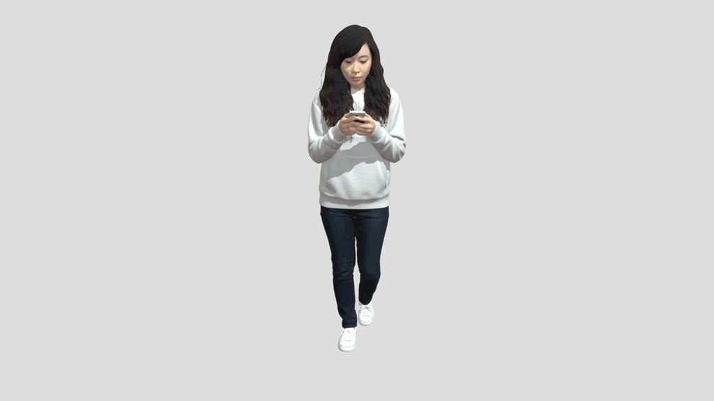 Young woman in a hoodie looking at her phone