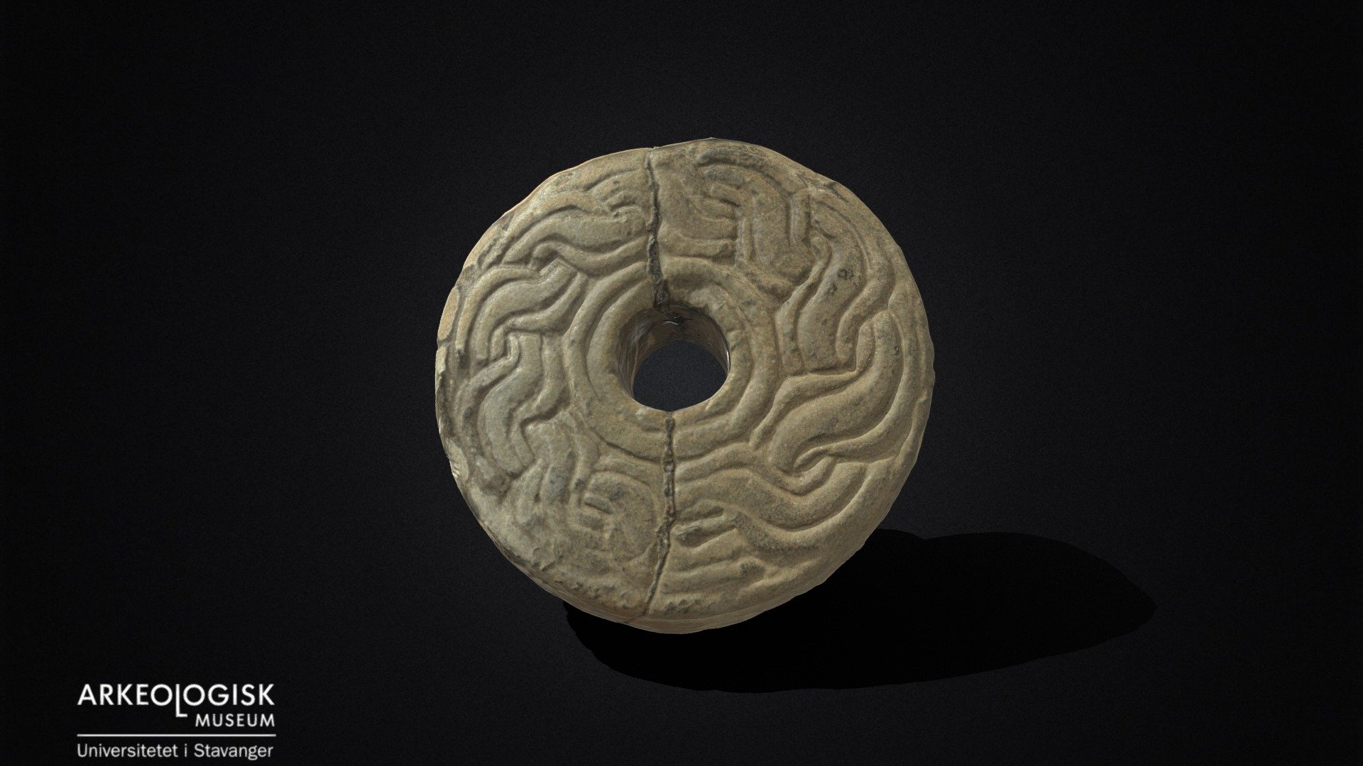 Ornamented spinning wheel of clay.