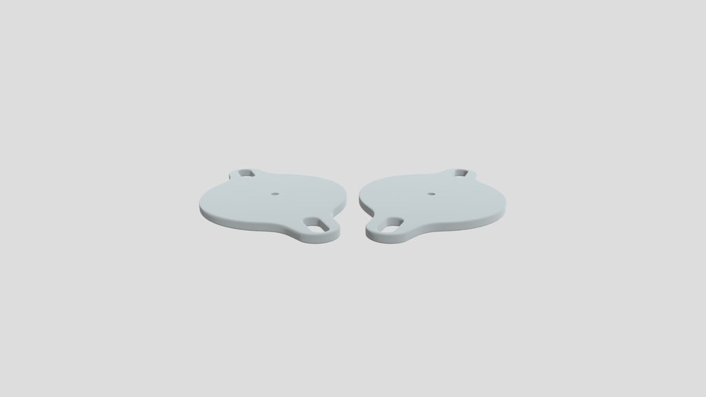 Two round metal discs with loops