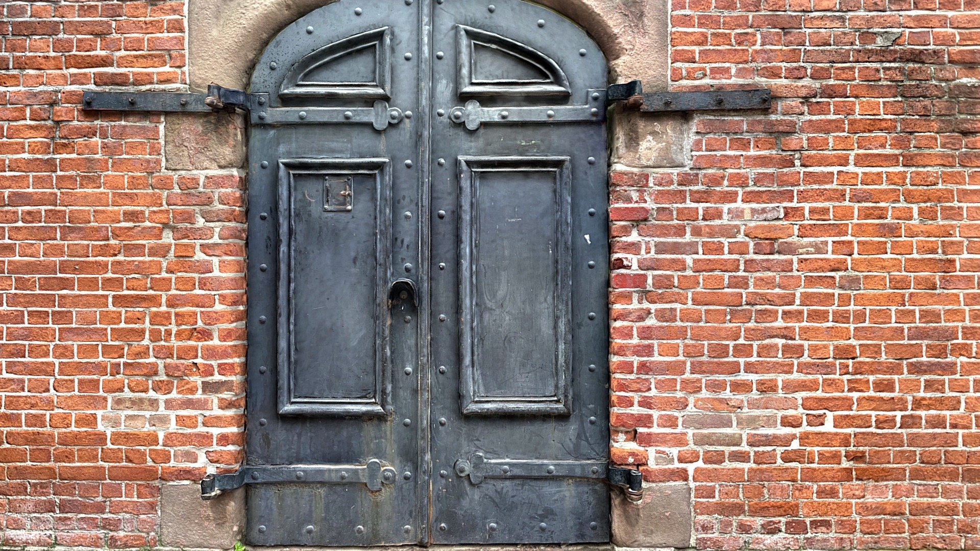 Heavy Rusty Metal Door to a Church + brickwall