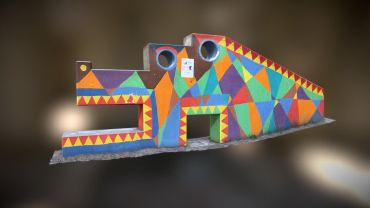 Crocodile toy on sandbox
