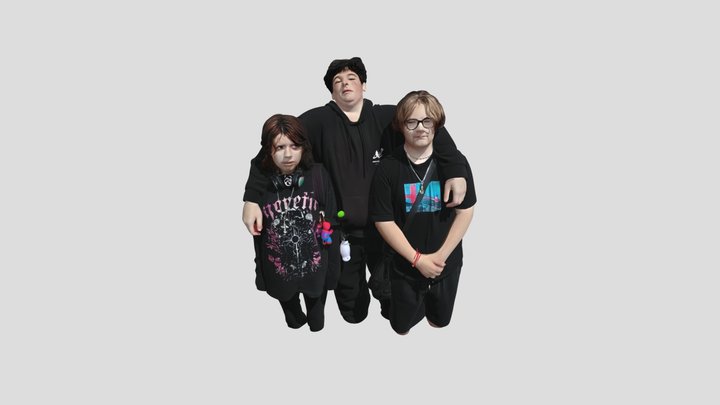 Three people posing together on a sidewalk