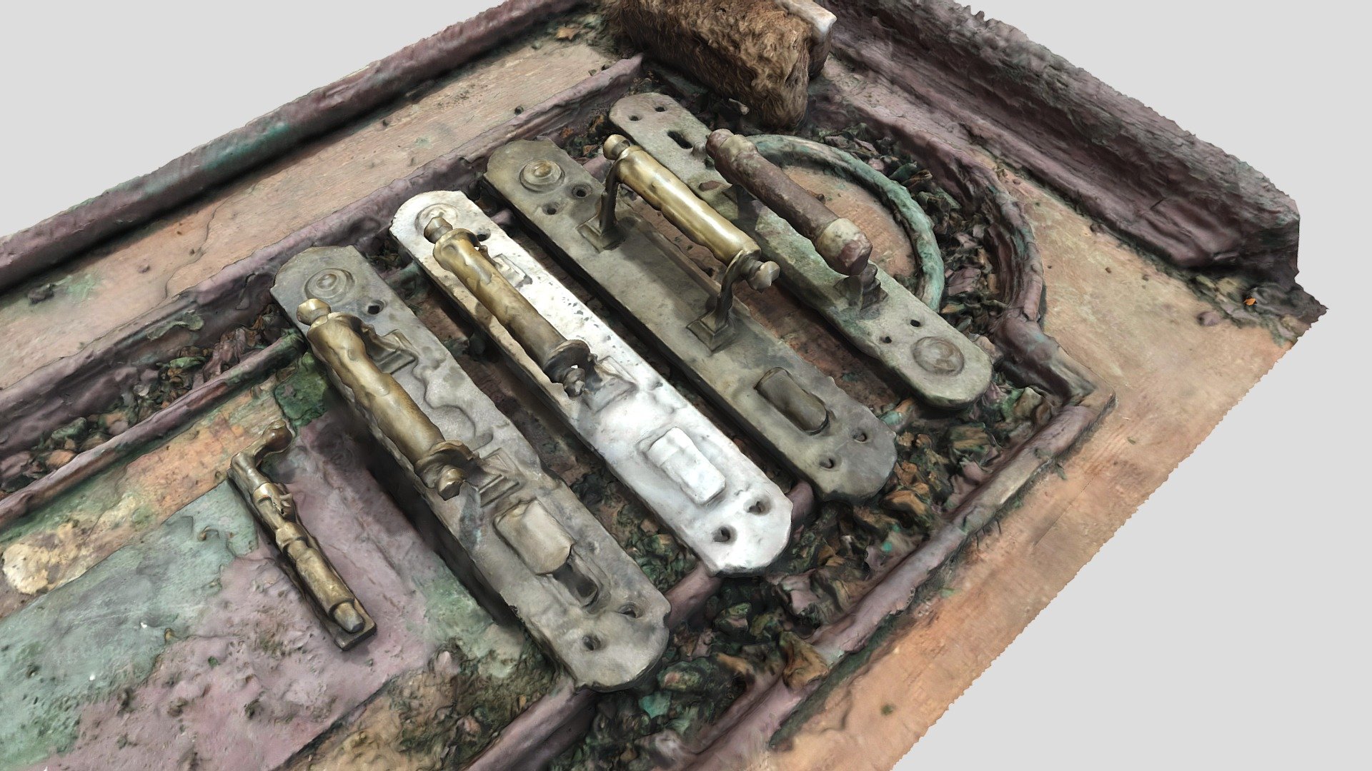 Vintage doorknobs and a latch on an antique door
