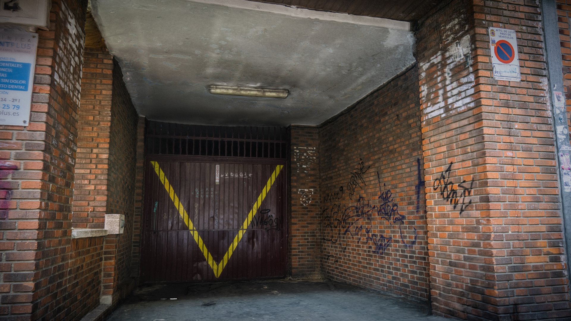 3D model Graffitied garage burgonuevo Photogrammetry scan - This is a 3D model of the Graffitied garage burgonuevo Photogrammetry scan. The 3D model is about a brick building with a yellow door.