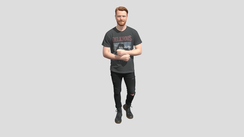 Redheaded man in a black tee and ripped jeans