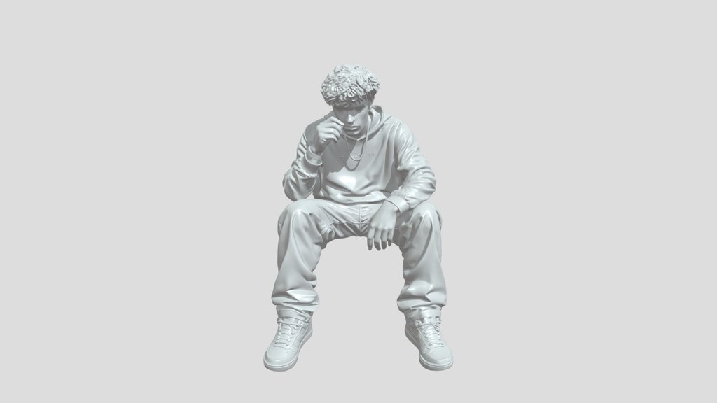 Seated man lighting a cigarette