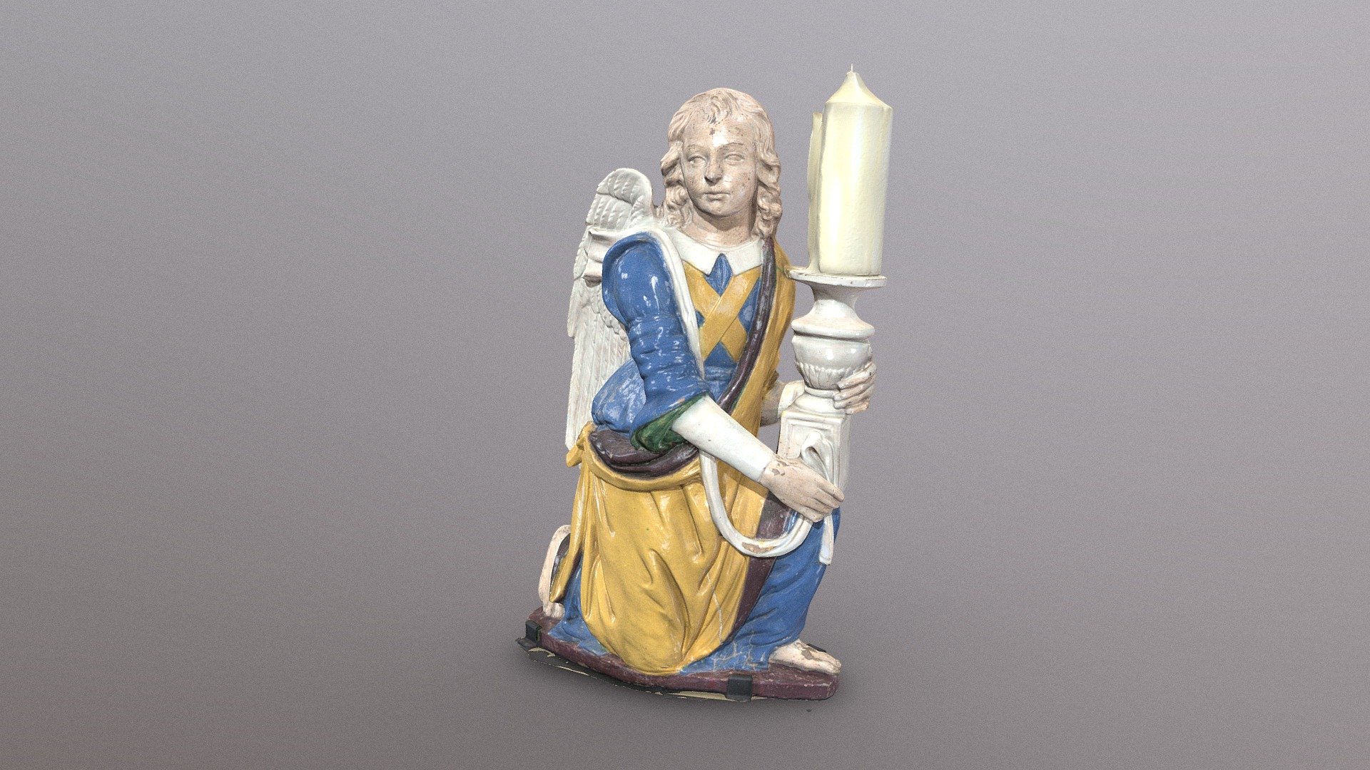 Kneeling angel holding a candlestick