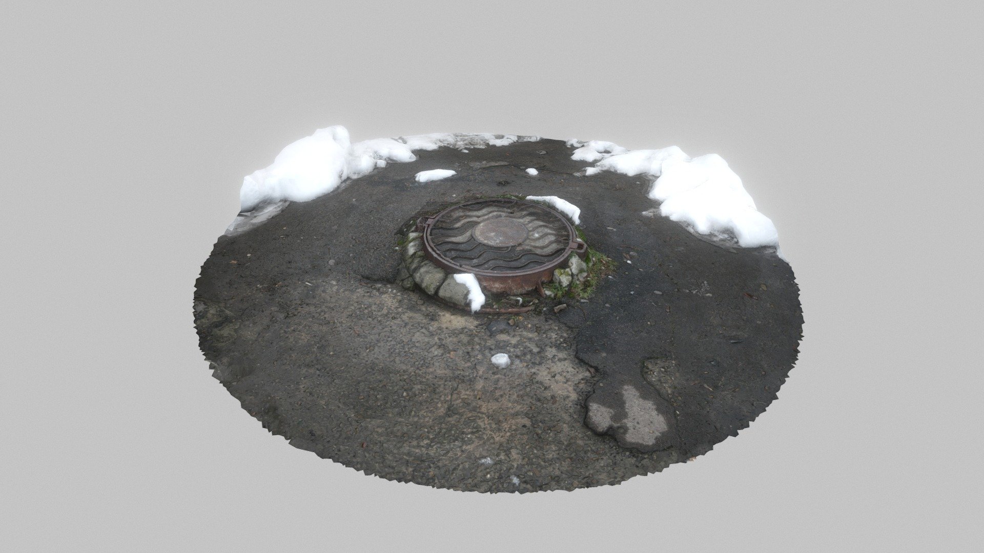Metal manhole cover in winter