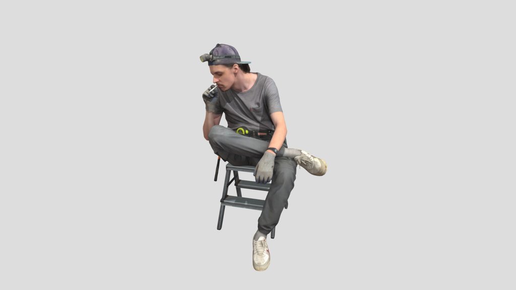 Worker In Gray Sits Smoking