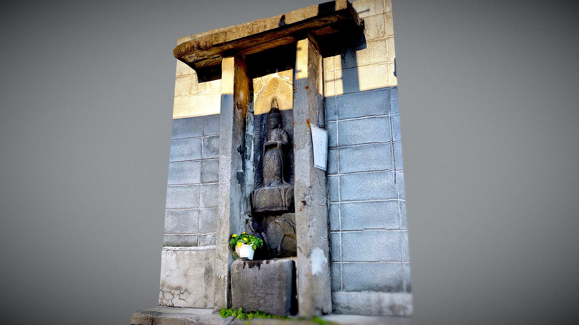 Kannon embedded in a concrete block
