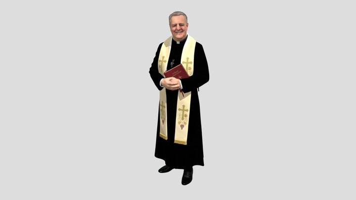 Priest in ceremonial vestments holding a Bible